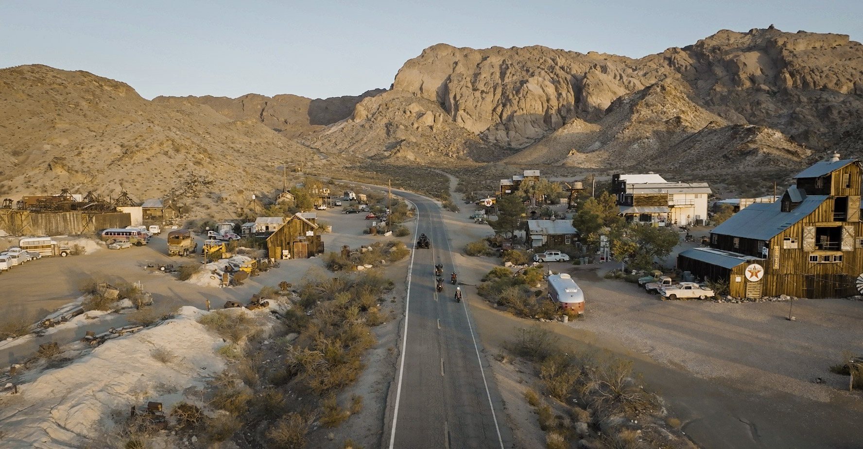 Aerial of a desert ghost town and the highway through it