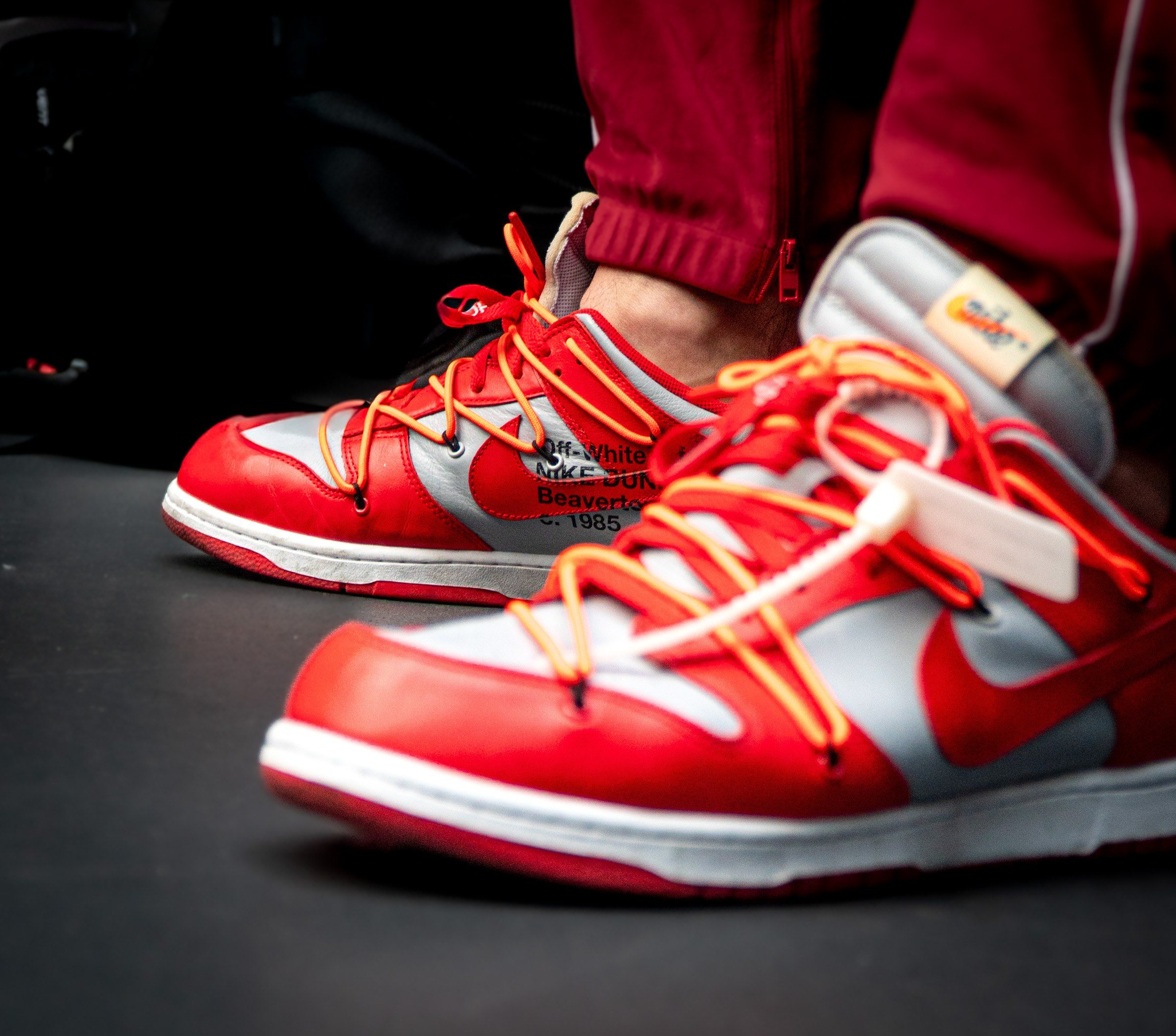 Red sneakers with orange laces on the gym floor