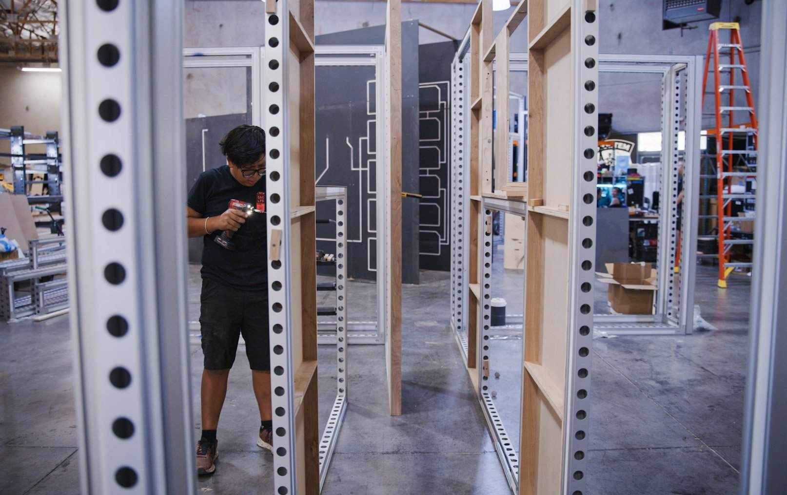 Builder working inside the steel frame of the exhibit