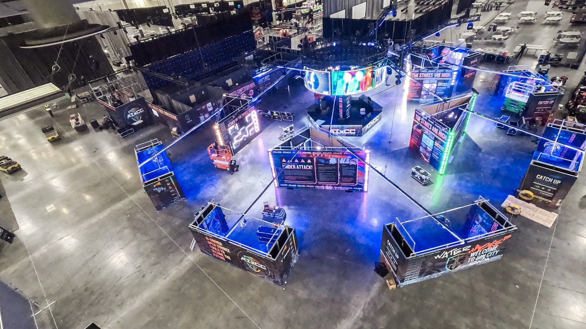 Overhead of glowing booths on the convention floor