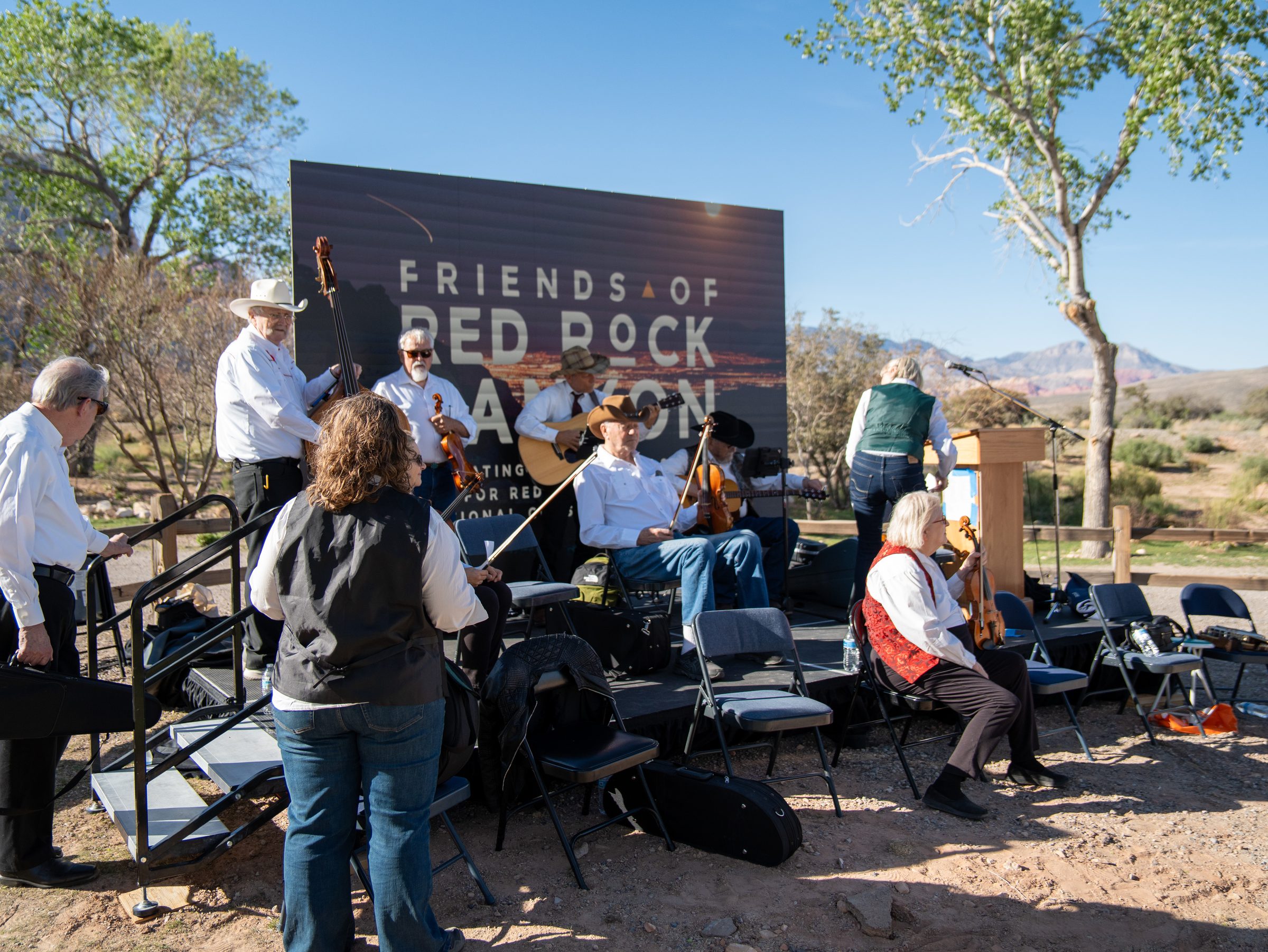 Musicians in front of the Friends of Red Rock Canyon banner