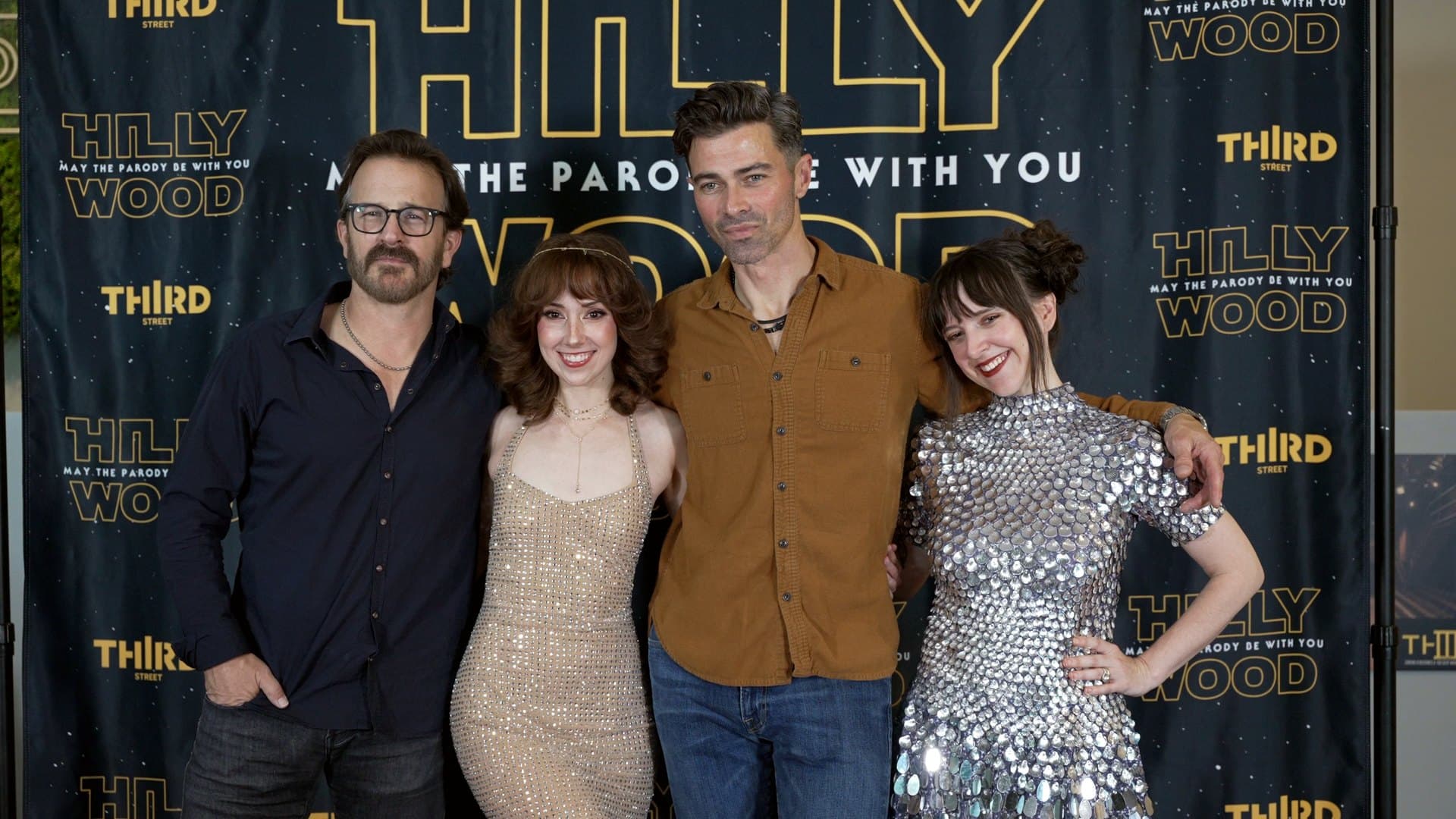 Hilly Hindi and the parody's cast on the step and repeat