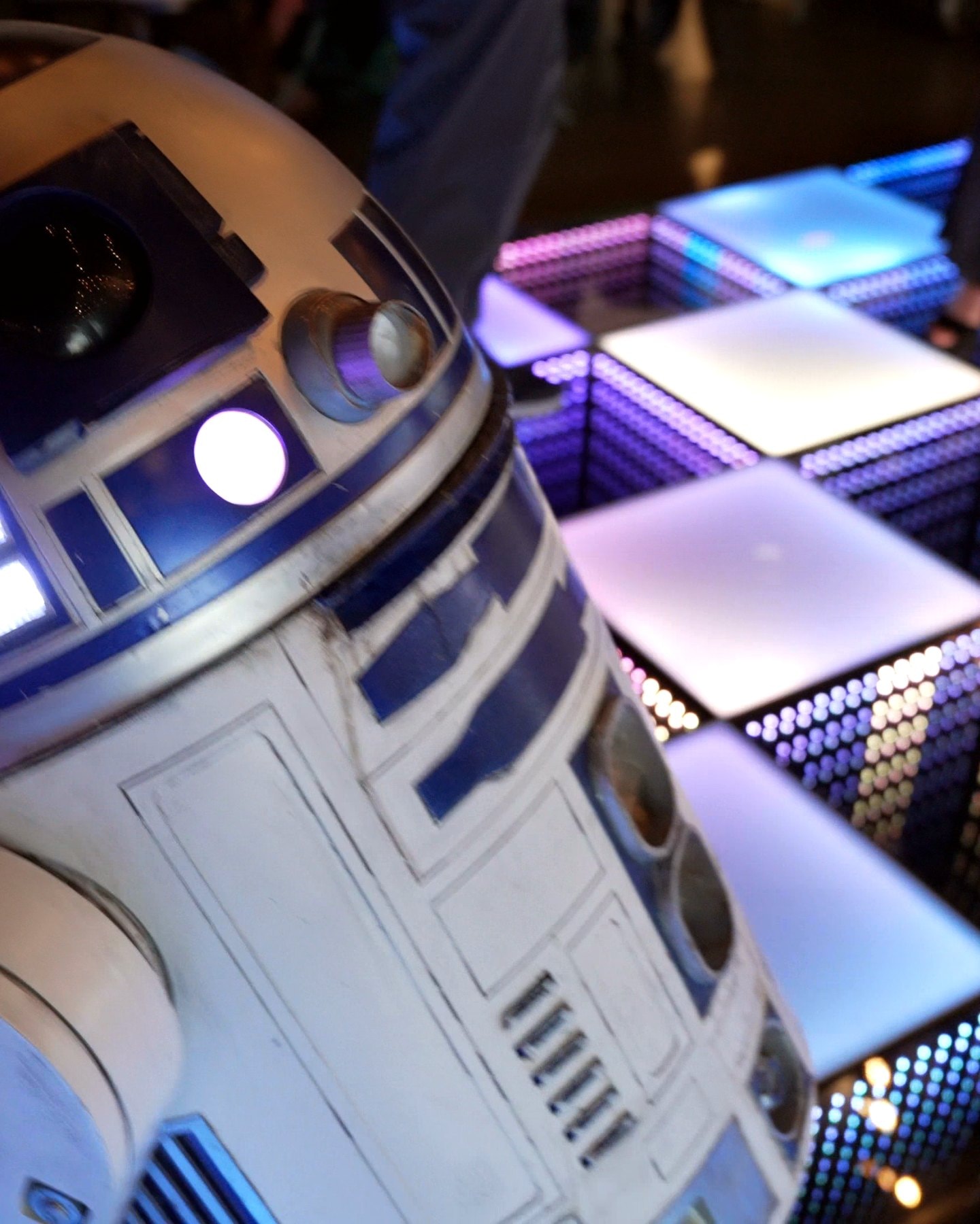 R2-D2 rolling across the LED dance floor at the after-party