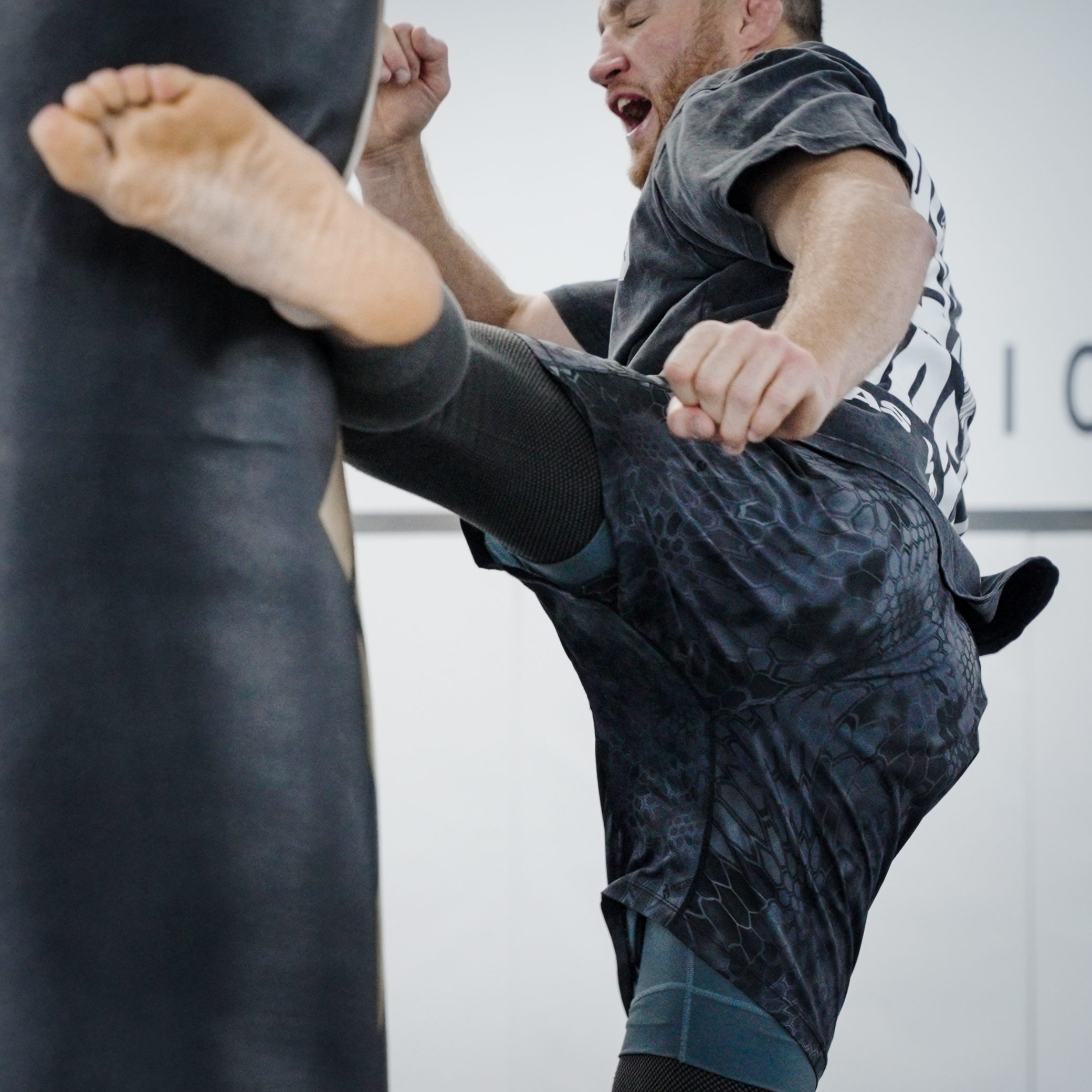 Gaethje landing a kick on a heavy bag