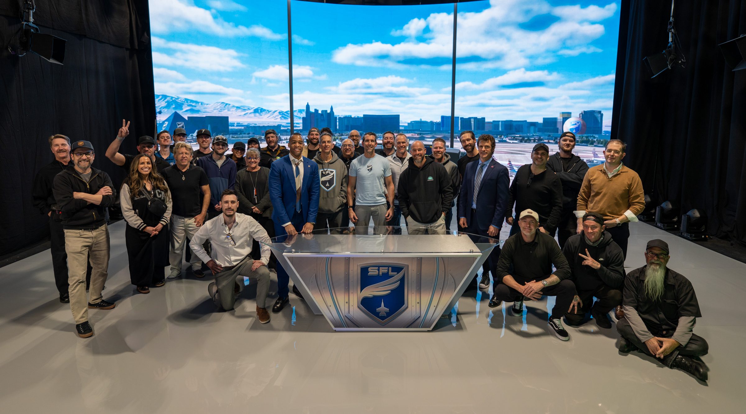Full cast and crew gathered around the SFL desk on the XR stage