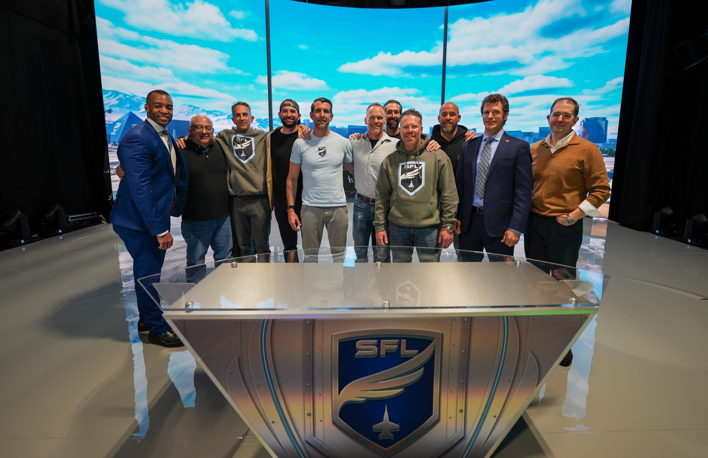 Hosts and league team posing behind the SFL desk