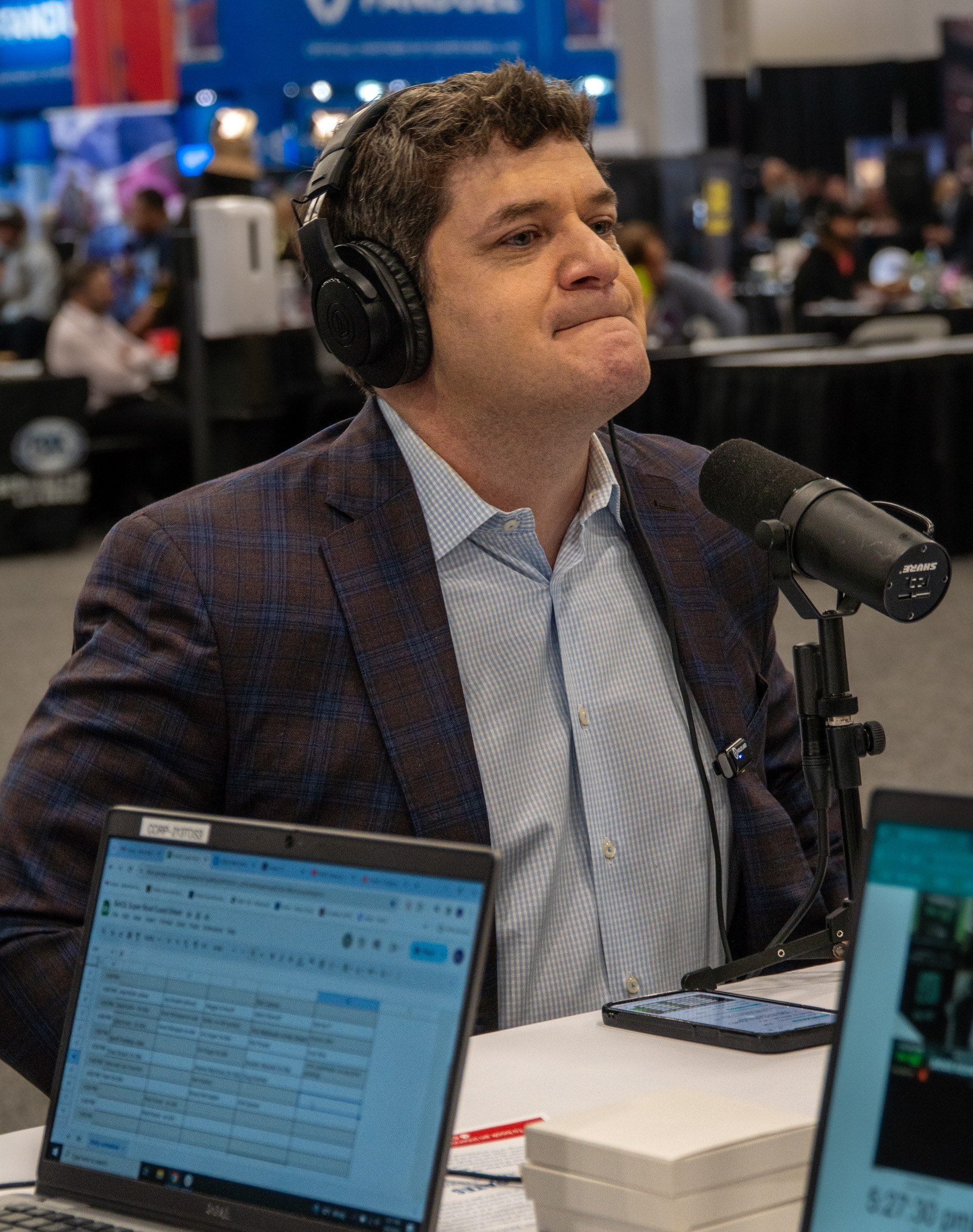 Host in headphones broadcasting from Radio Row