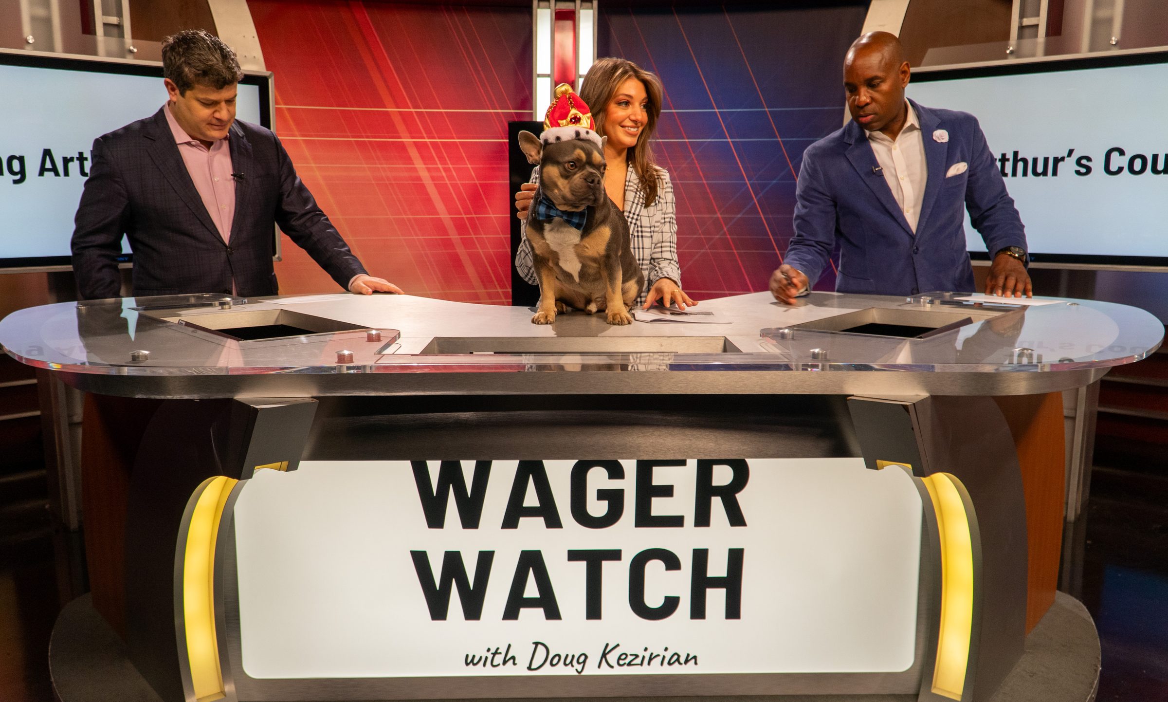 Wager Watch hosts with a French bulldog guest at the desk